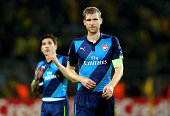Defender Per Mertesacker watches on with his Arsenal teammate Hector Bellerin