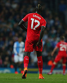 Liverpool defender Mamadou Sakho holds on to his hamstring