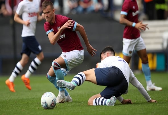 Preston North end defender Josh Earl tackles West Ham attacker Andriy Yarmolenko