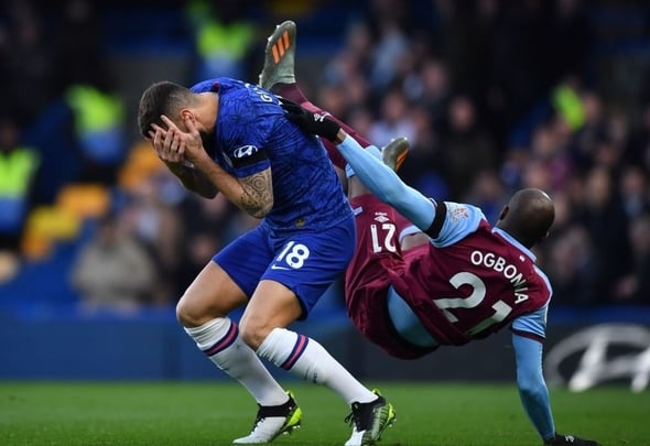 Chelsea attacker Olivier Giroud gets clattered by West Ham defender Angelo Ogbonna