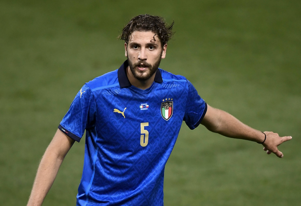 Manuel Locatelli with his arm outstretched looking focused