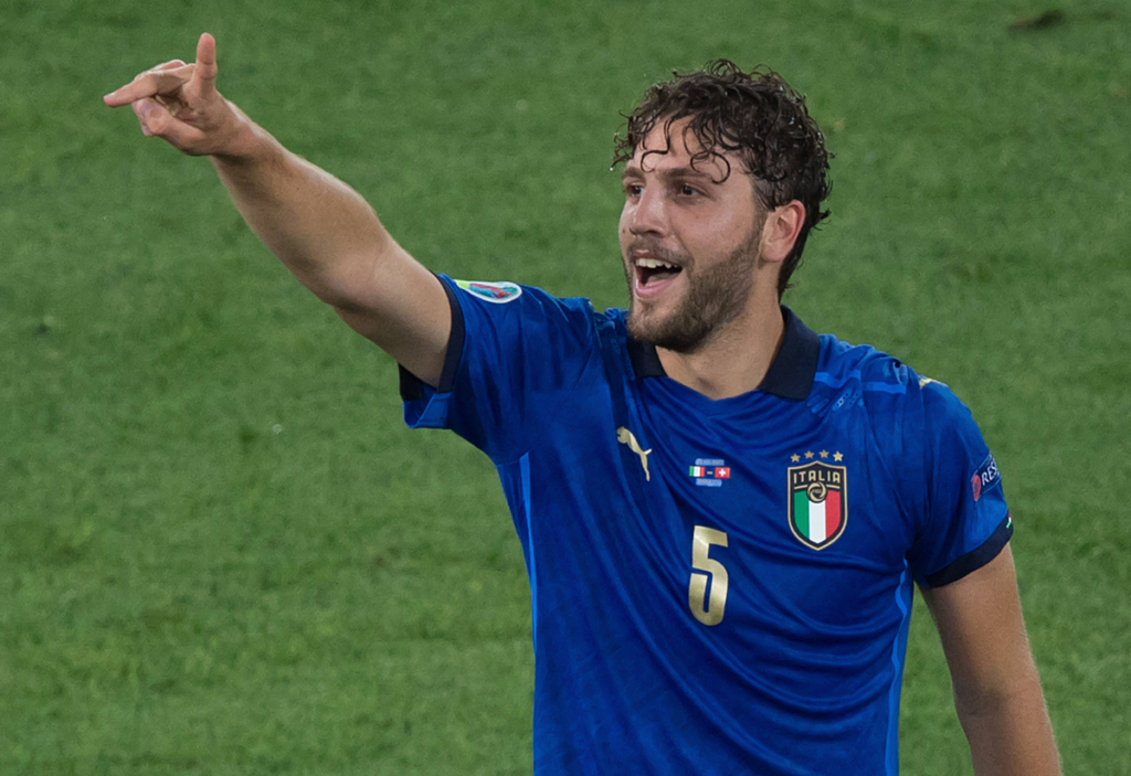 Manuel Locatelli with his finger pointed in the air shouting