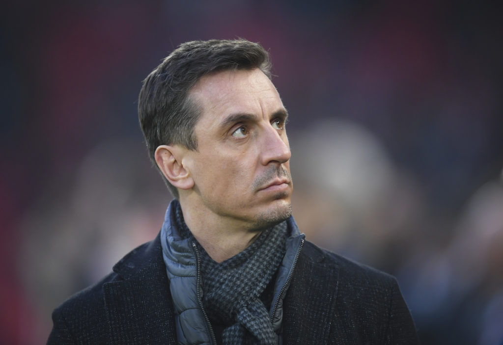 Gary Neville looking towards the sky wearing a grey scarf