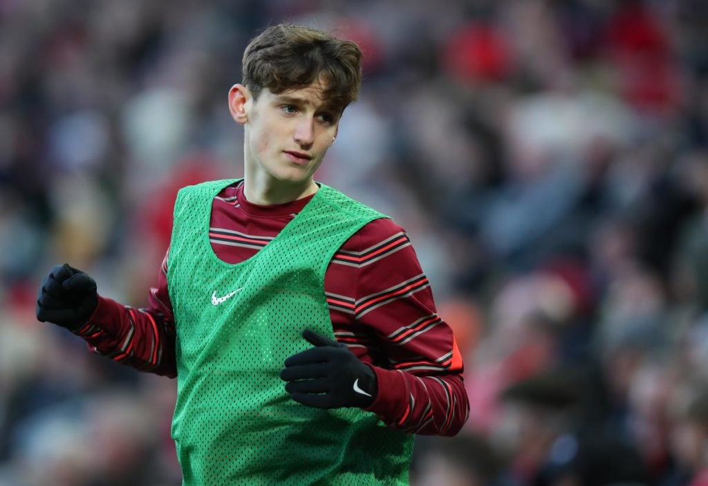 Liverpool midfielder Tyler Morton warming up on the side lines.