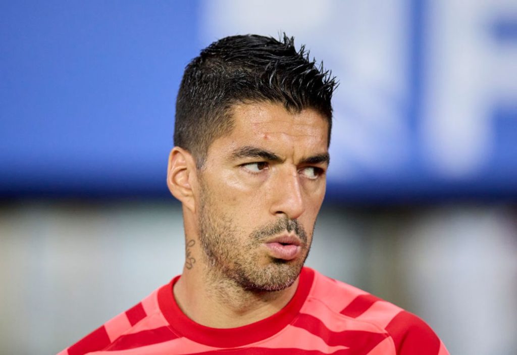 Luis Suarez looking focused in a red shirt