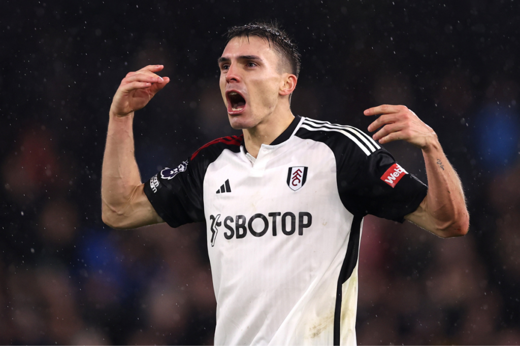 Joao Palhinha in a Fulham shirt in black and white shouting to encourage the team