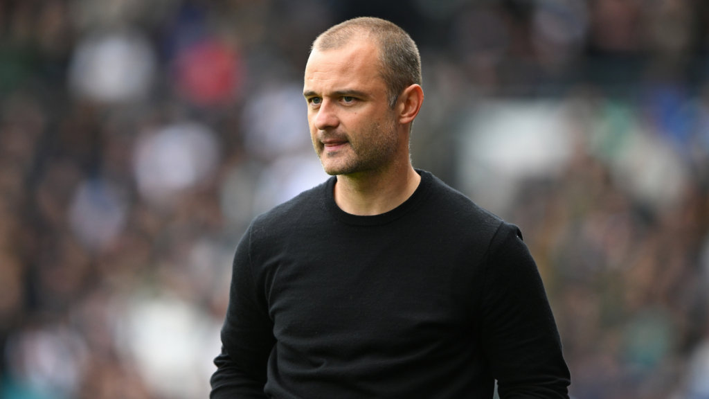 Celtic assistant manager Shaun Maloney stands on the touchline.