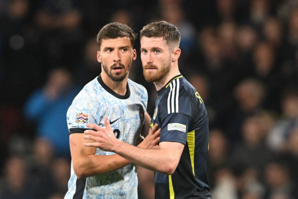 Celtic star Anthony Ralston marking Ruben Dias during a game for Scotland.