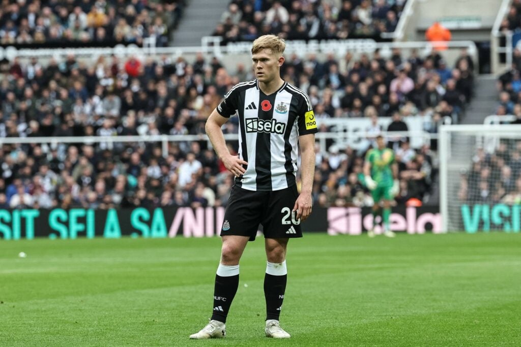 Lewis Hall with his hands on his hips playing for Newcastle