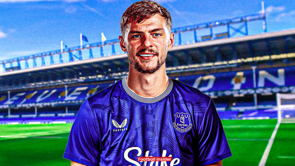 Kiernan Dewsbury-Hall posing in an Everton shirt in front of Goodison Park.