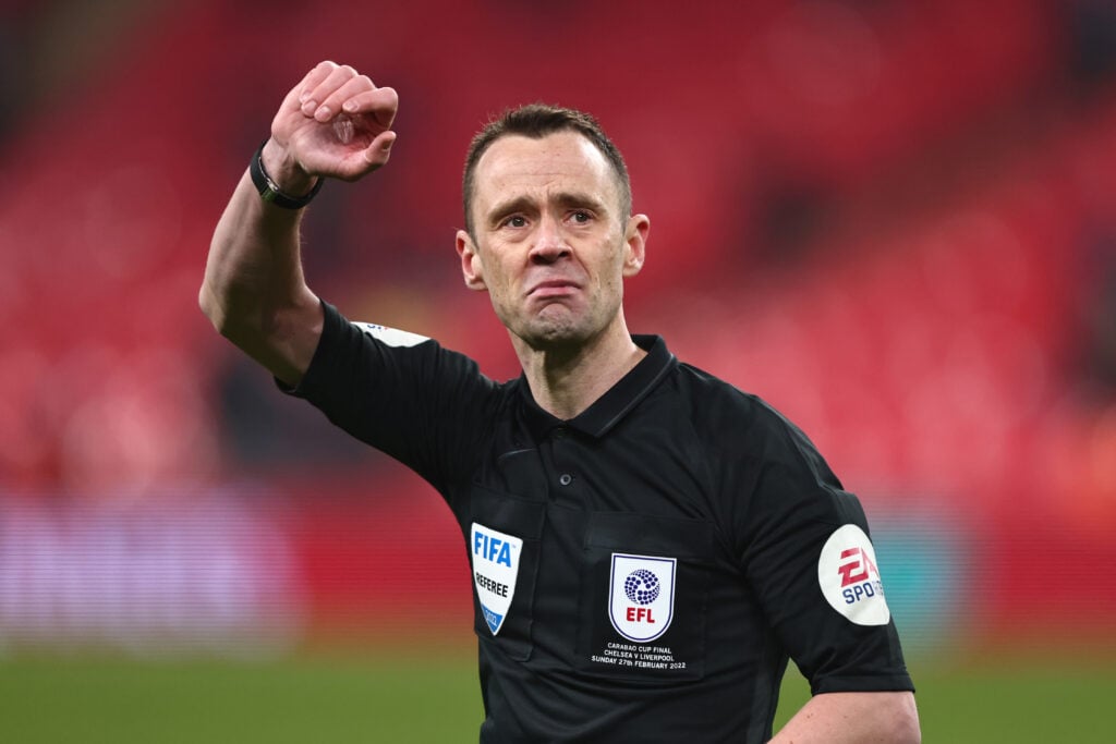 Premier League referee Stuart Attwell with his hand in the air
