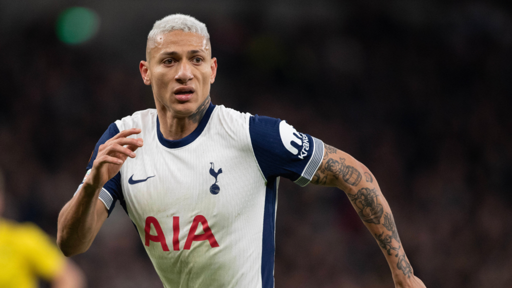 Tottenham forward Richarlison in white and black shirt running