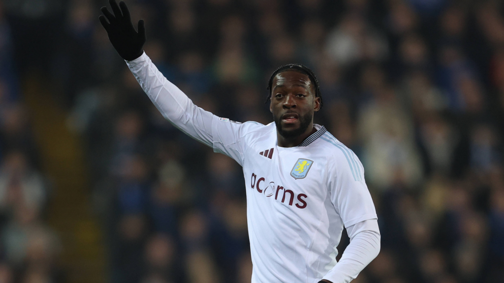 Axel Disasi Aston Villa in a white shirt with his hand in the air
