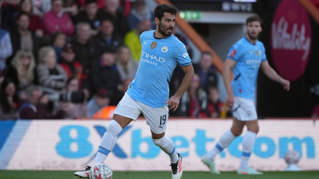 Ilkay Gundogan playing for Man City at Bournemouth with team mate Ruben Dias in the background.