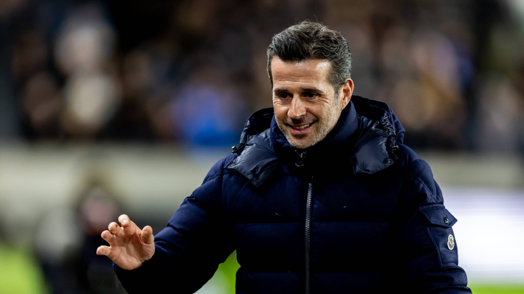 Marco Silva smiles on the pitch at Craven Cottage