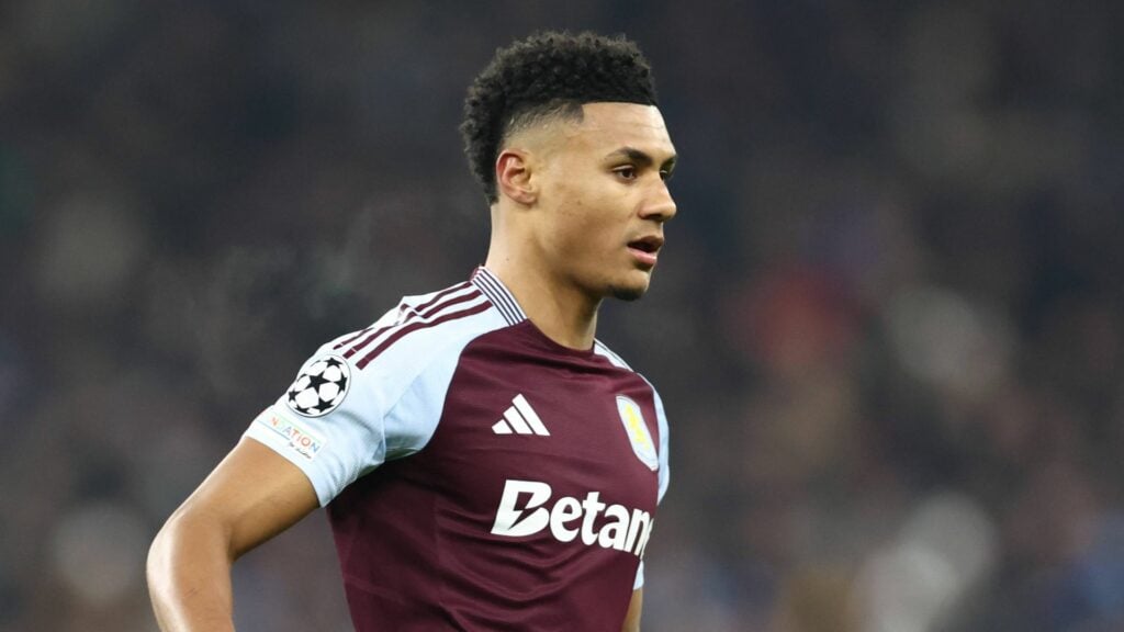 Ollie Watkins in a home Aston Villa jersey during a Champions League match.