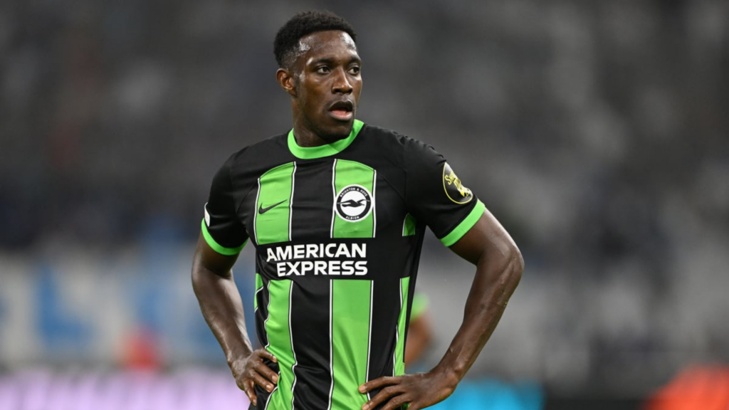 Danny Welbeck with hands on hips in an away Brighton shirt