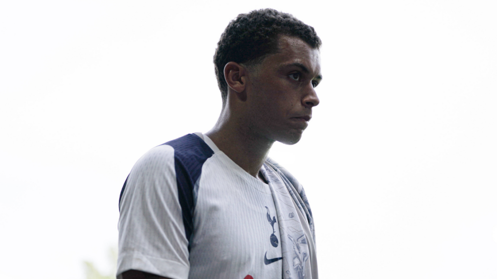 Brennan Johnson with his face in shadow wearing a Tottenham shirt