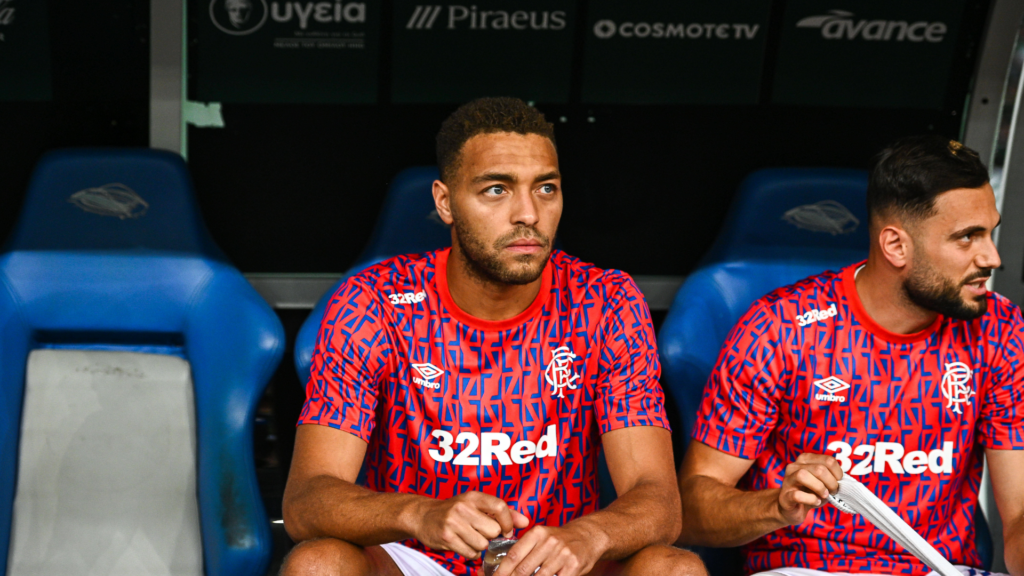 Cyriel Dessers sat on the Rangers bench