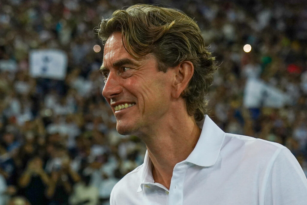 Thomas Frank smiling on the Tottenham touchline