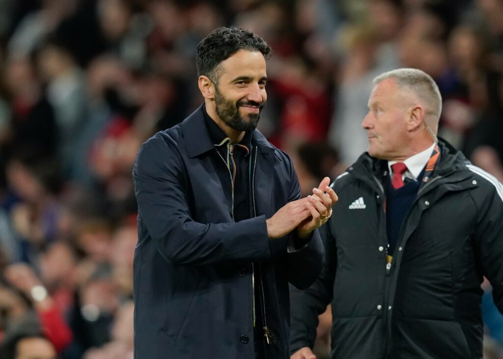 Ruben Amorim smirking on the Old Trafford touchline.