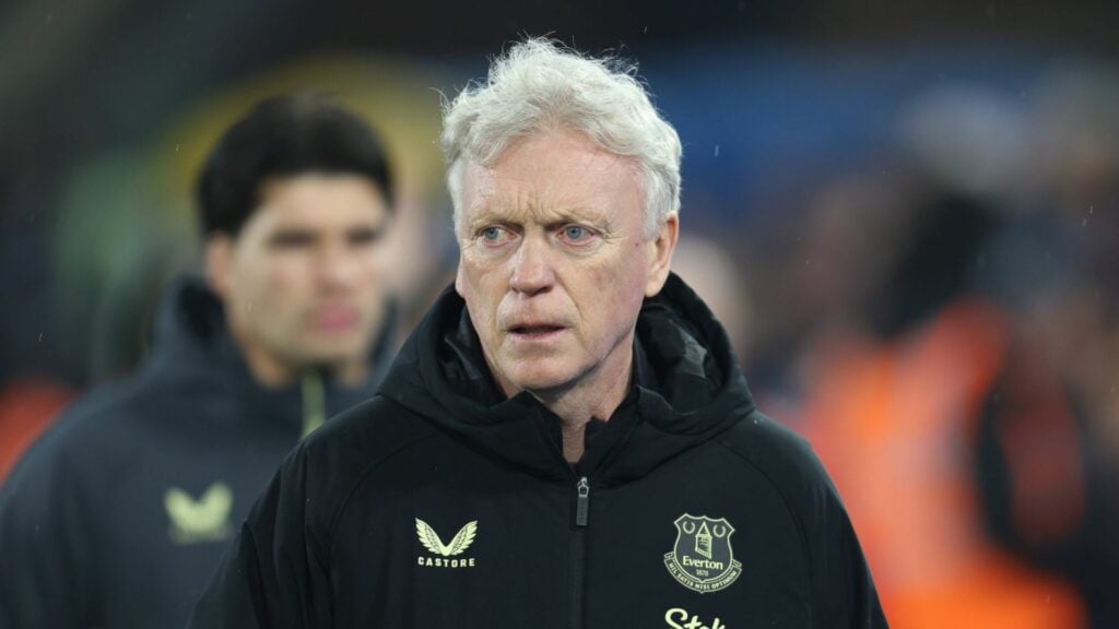 Everton manager David Moyes looking angry following a Premier League match, with former goalkeeper Joao Virginia in the background