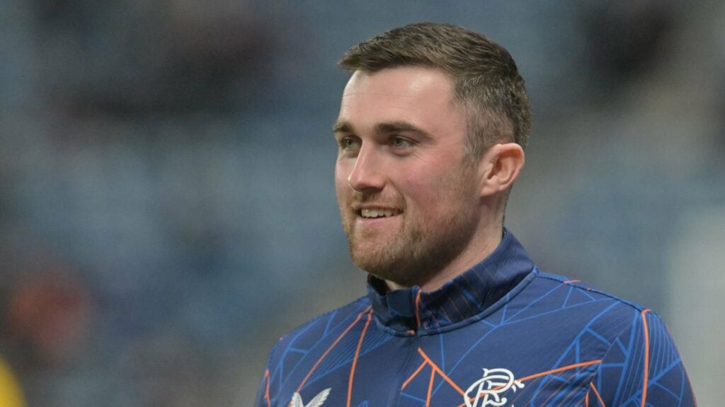 John Souttar smiles in a Rangers jacket