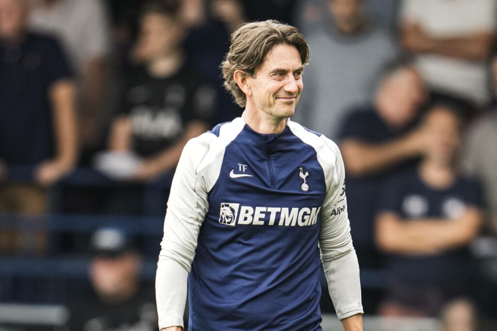 Thomas Frank Tottenham in blue and white tracksuit top smiling