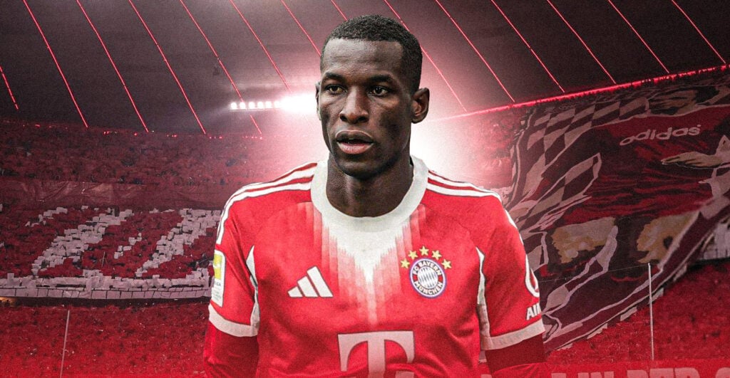 Nicolas Jackson looking focused in a Bayern Munich shirt in front of the Allianz Arena