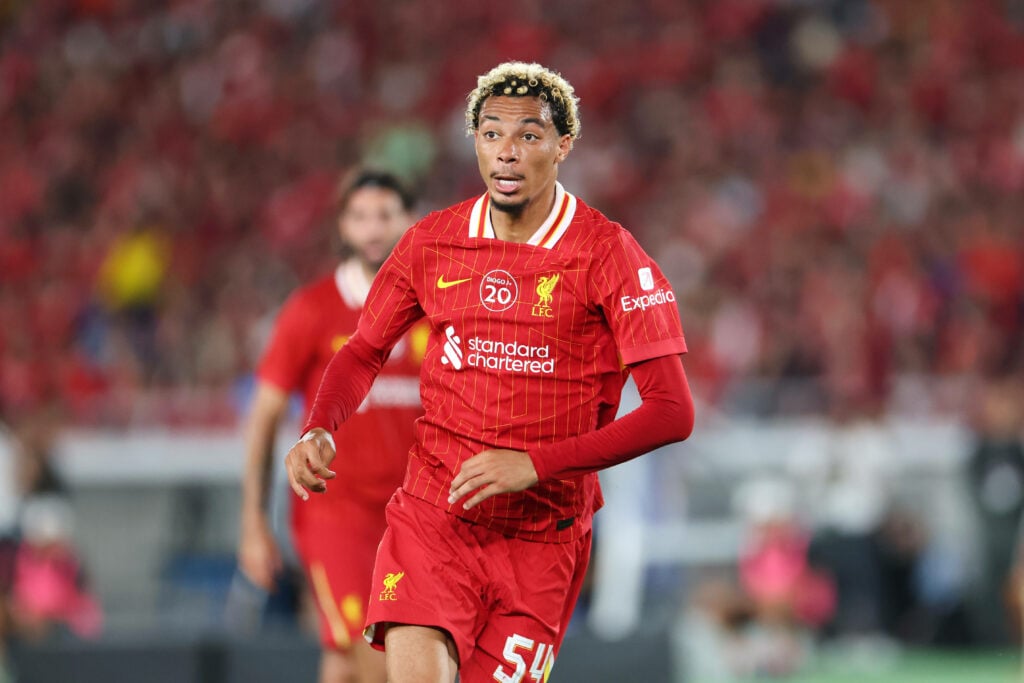Hugo Ekitike running in a Liverpool shirt looking focused