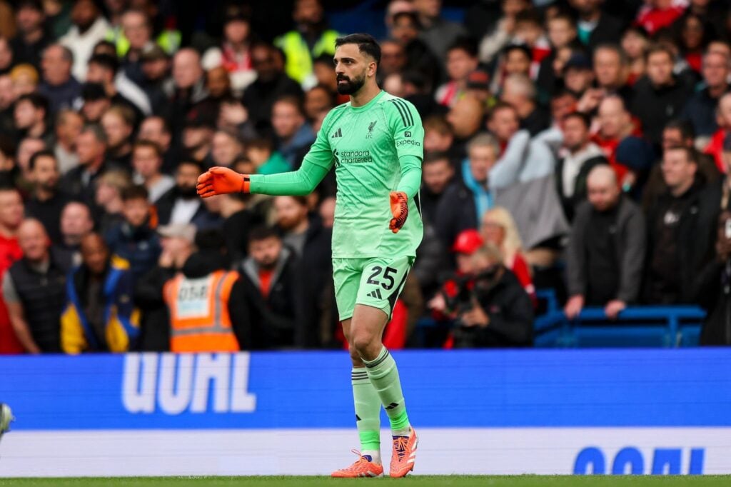 Giorgi Mamardashvili clapping his hands in a green Liverpool shirt