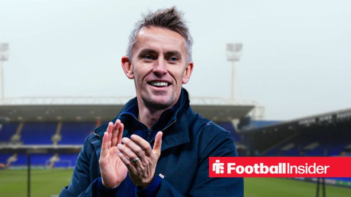 Ipswich Town manager Kieran McKenna clapping and smiling against a backdrop of Portman Road.