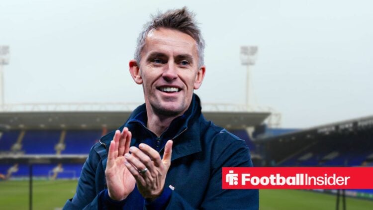 Ipswich Town manager Kieran McKenna clapping and smiling against a backdrop of Portman Road.