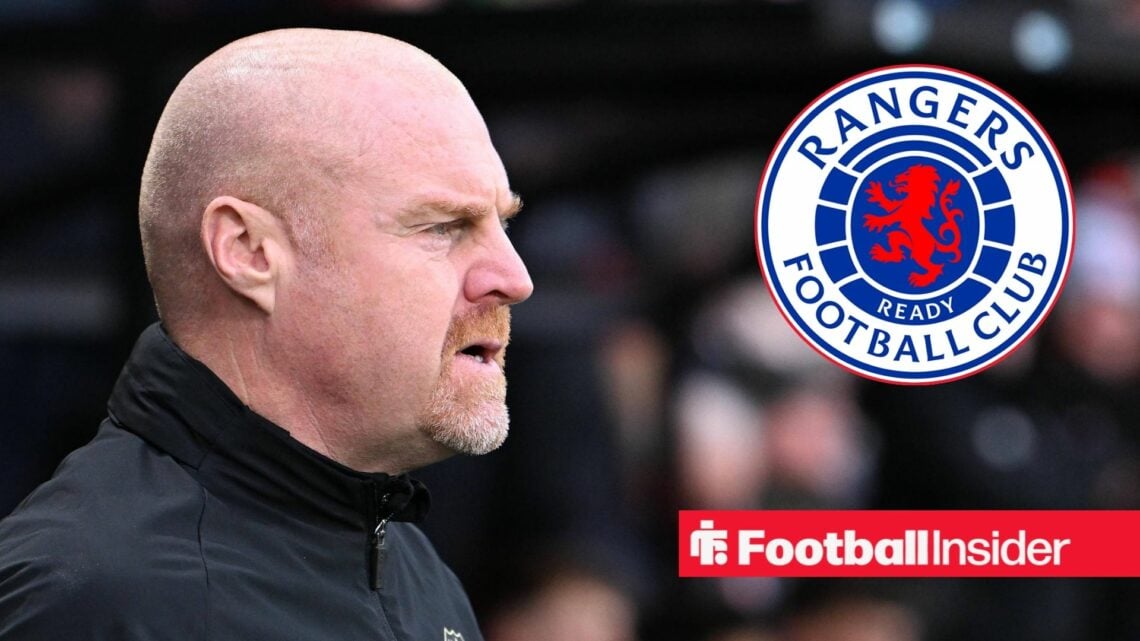 Sean Dyche looking focused on the left hand side looking at the Rangers club badge on the right