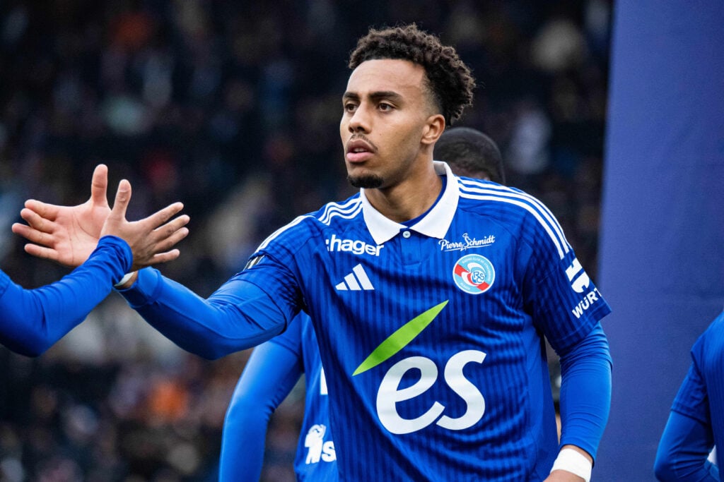 Guela Doue shaking hands with Strasbourg teammate