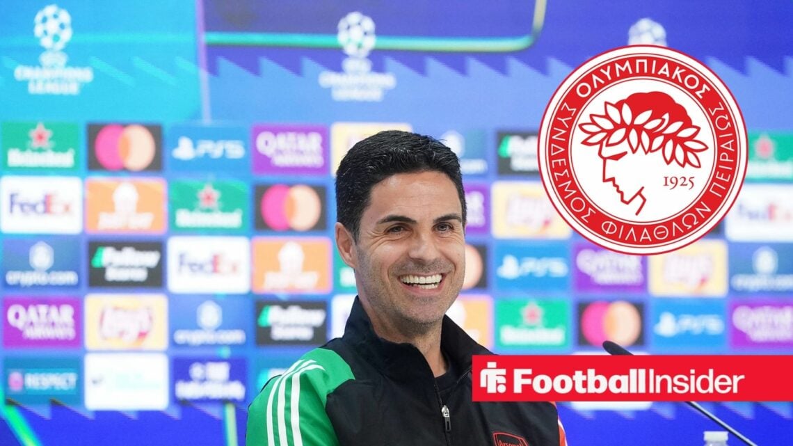 Mikel Arteta smiles during Champions League press conference with Olympiacos club badge inset