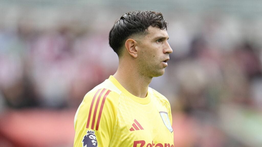 Aston Villa goalkeeper Emiliano Martinez stares out from his goal during a game.