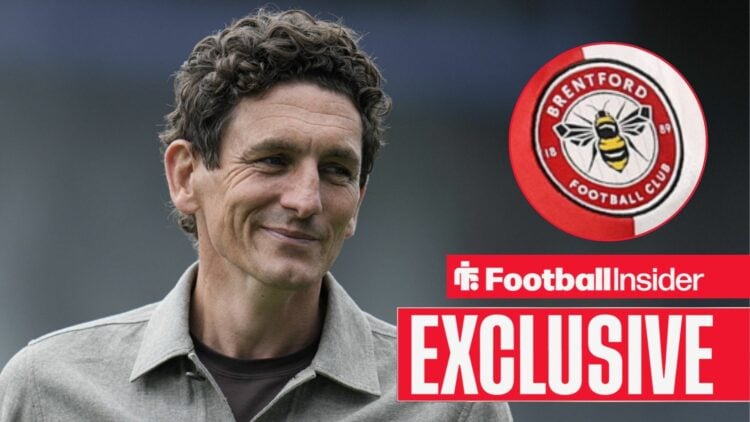 Football Insider exclusive as Keith Andrews smiles towards the Brentford badge, which features in a circular inset.