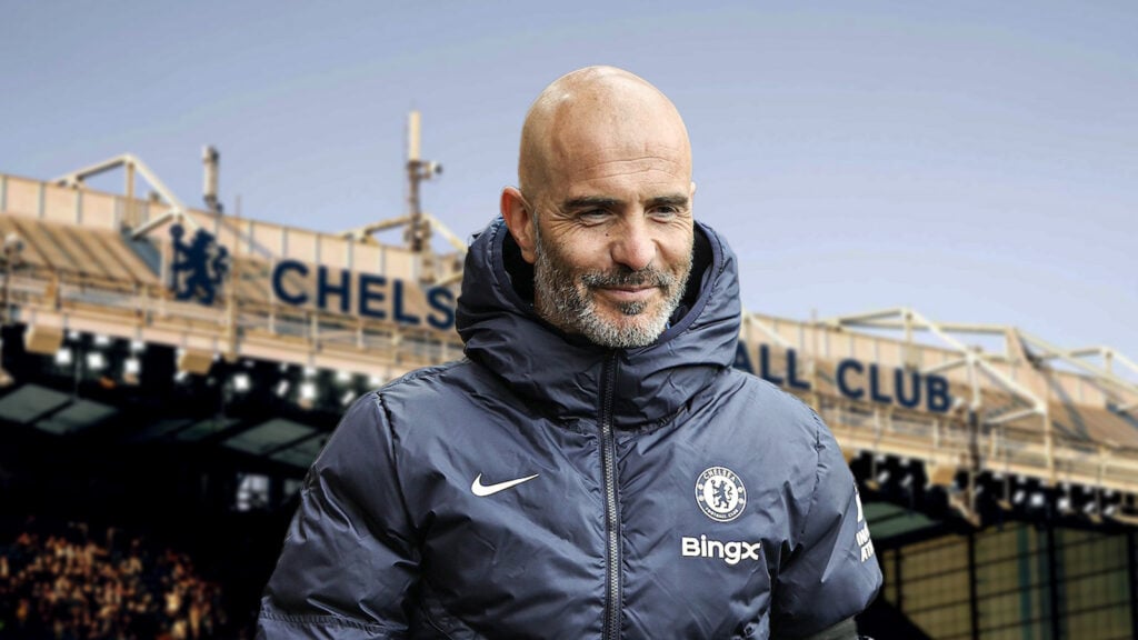 Chelsea manager Enzo Maresca smiles with Stamford Bridge in the background.