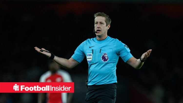 Premier League referee John Brooks holds out his arms