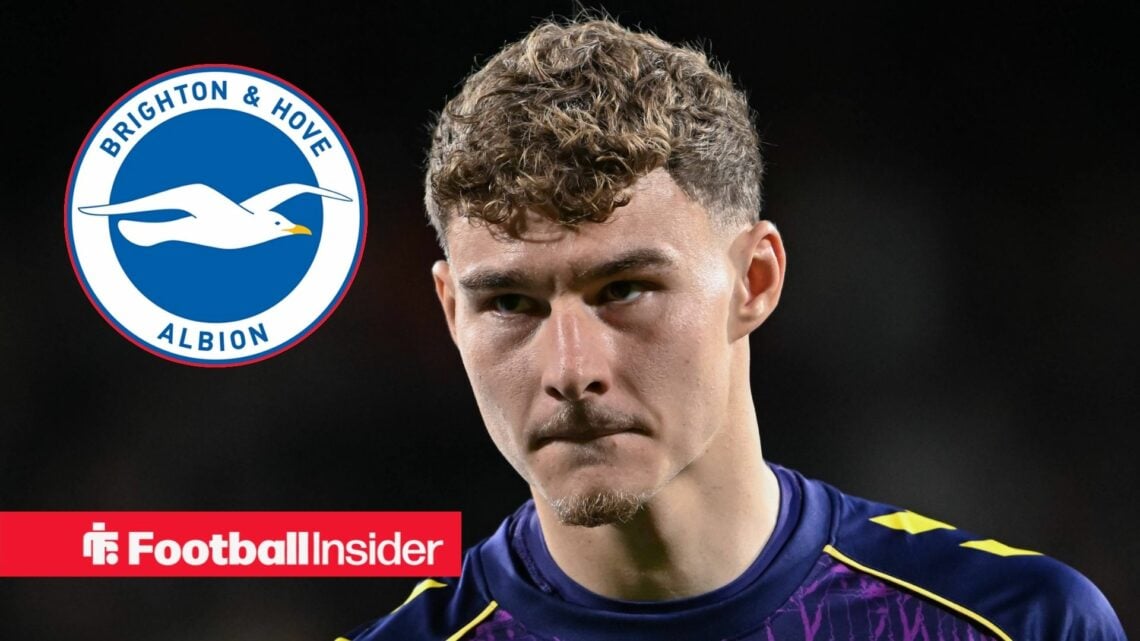 Carl Rushworth looking at Brighton badge in circle