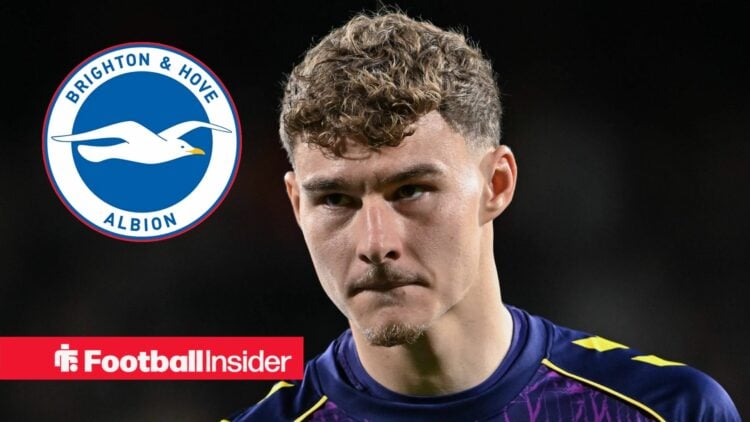 Carl Rushworth looking at Brighton badge in circle