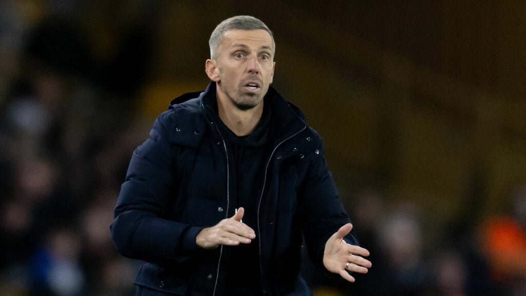 Ex-Wolves manager Gary O'Neil standing on the touchline.