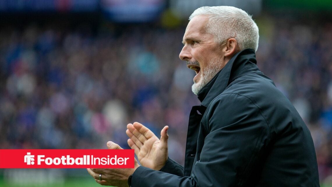 Dundee United manager Jim Goodwin applauds on the touchline.