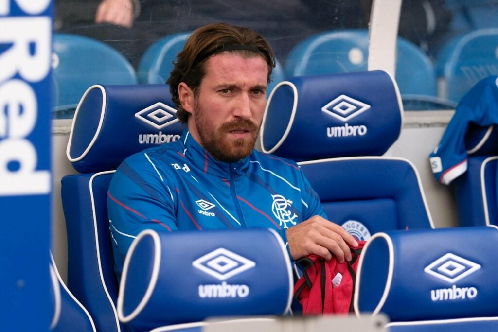 Rangers midfielder Joe Rothwell sits on the bench during a game.