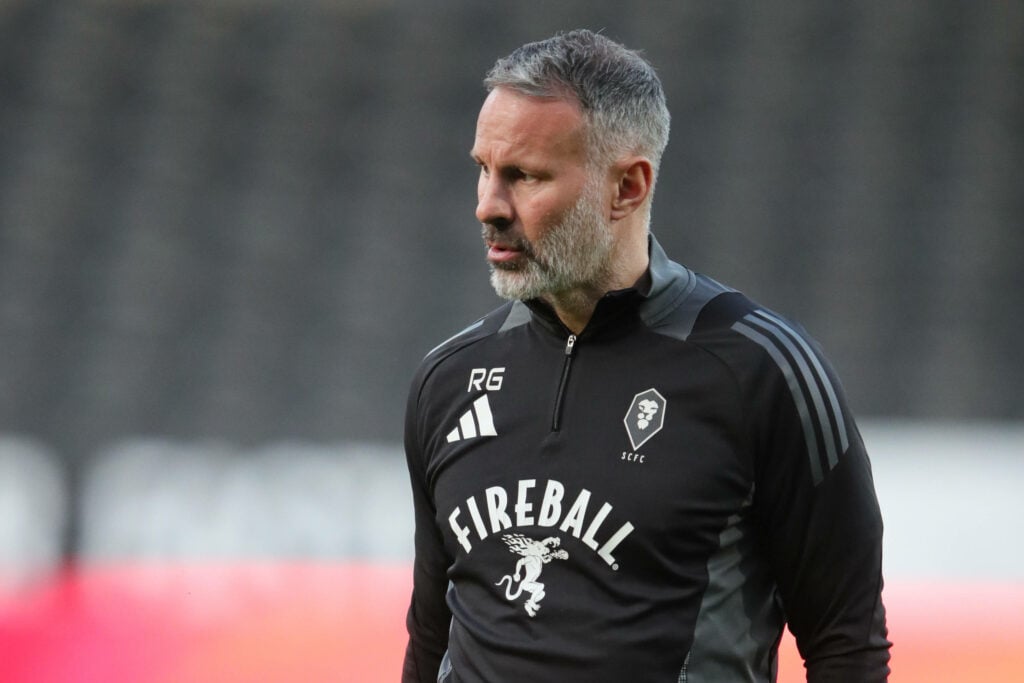 Salford City co-owner Ryan Giggs stands before a game.