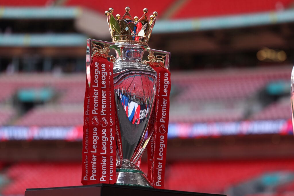 The Premier League trophy sits on a stand.