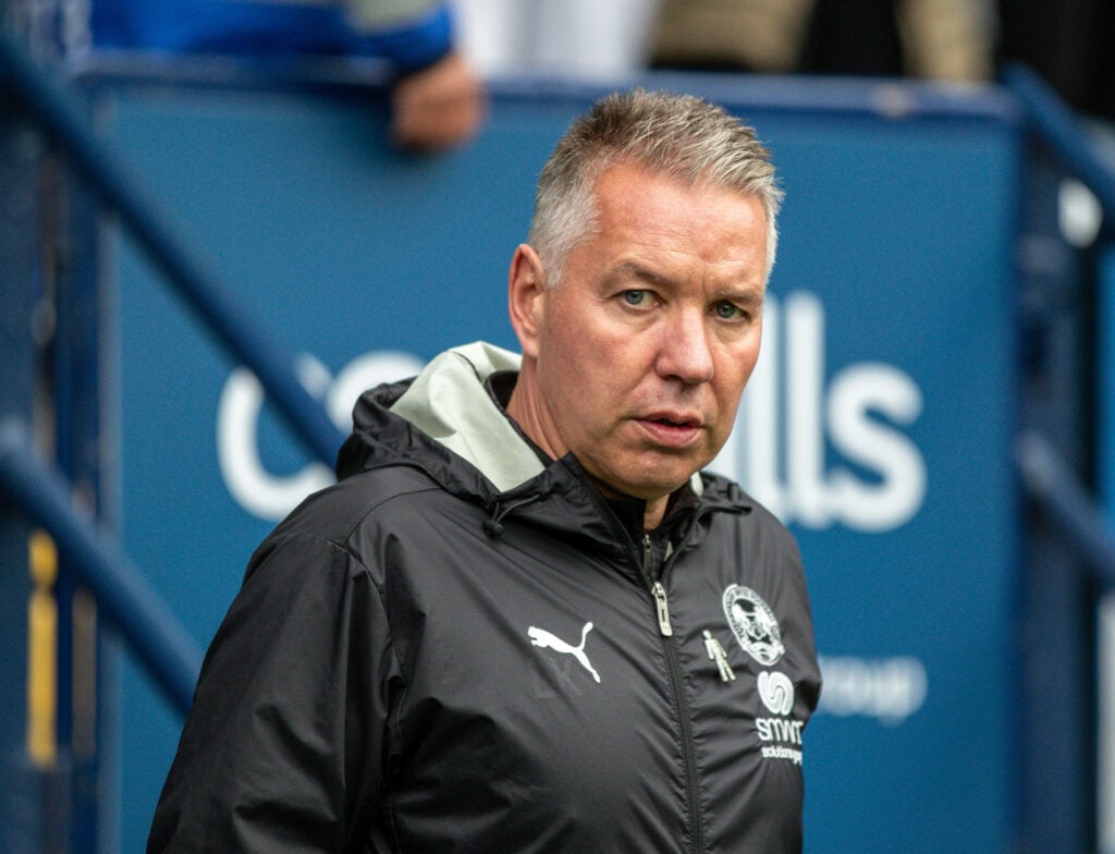 Former Peterborough United manager Darren Ferguson stands on the touchline.