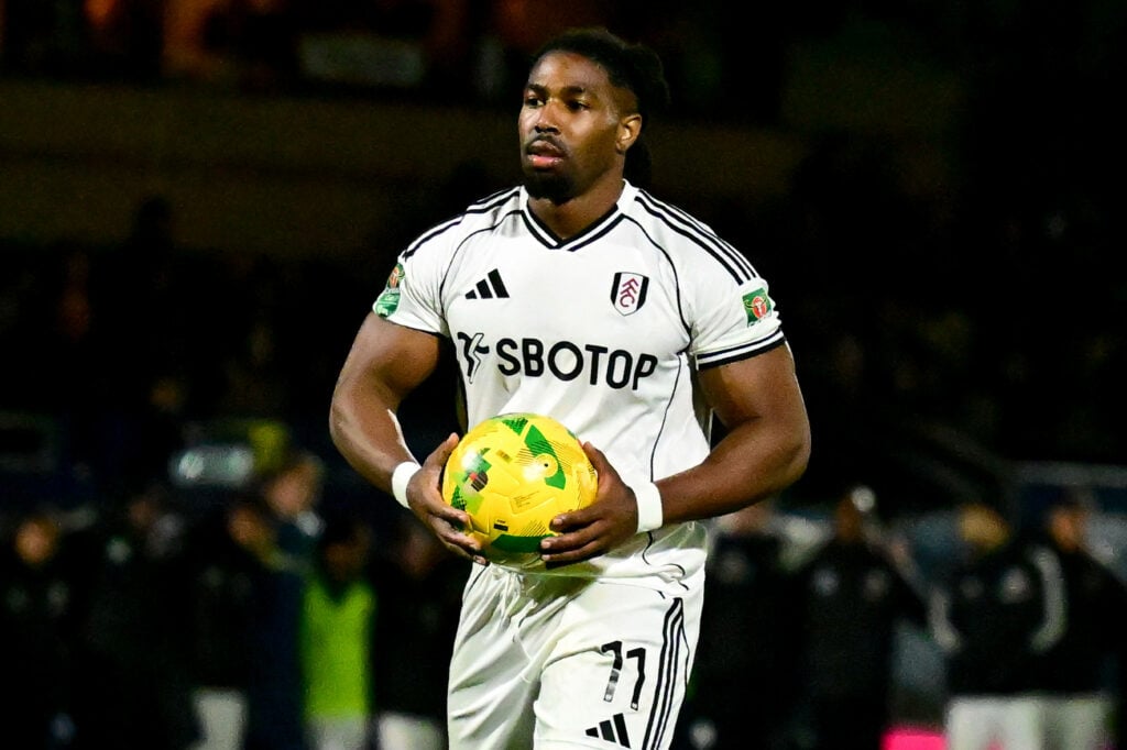 Adama Traore holds the ball in his hands during a game for Fulham.