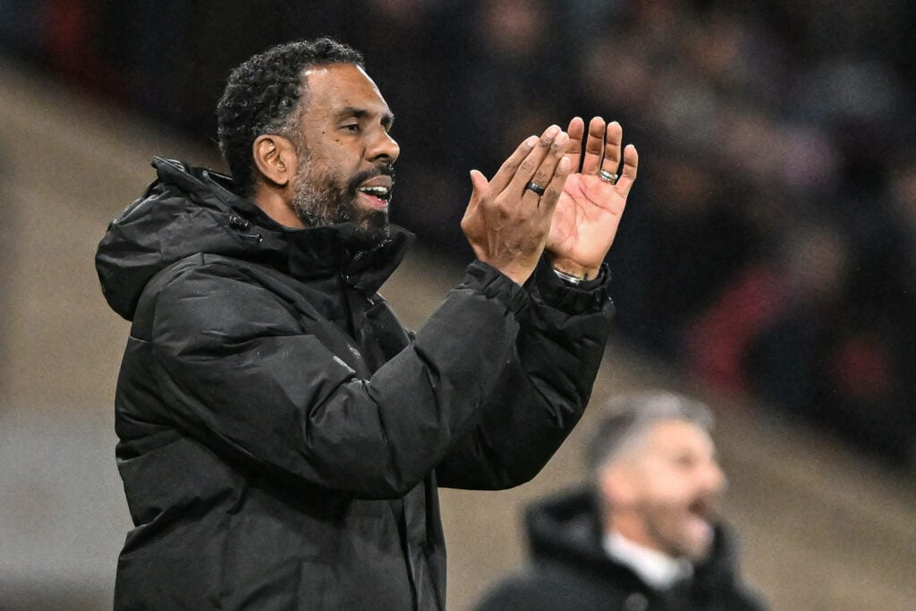 Celtic manager Wilfried Nancy applauds on the touchline during a game.